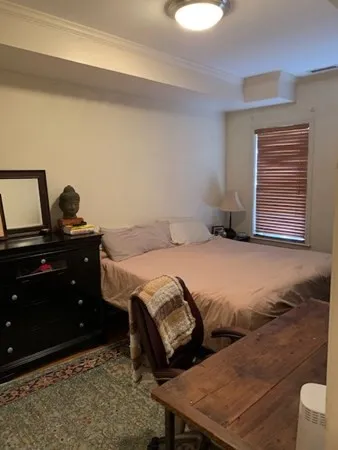 a bedroom with a bed and a dresser
