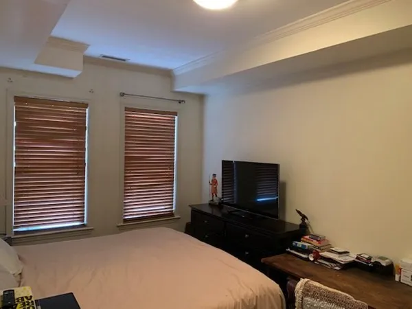 a bedroom with bed and a flat screen tv
