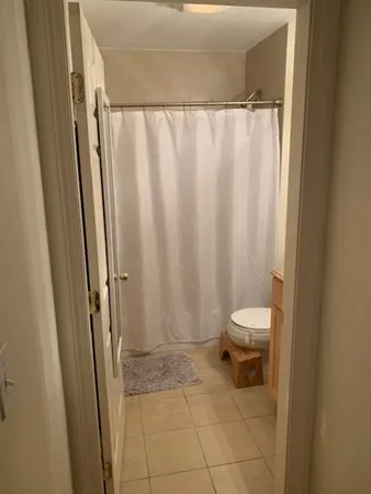 a bathroom with a toilet and a shower