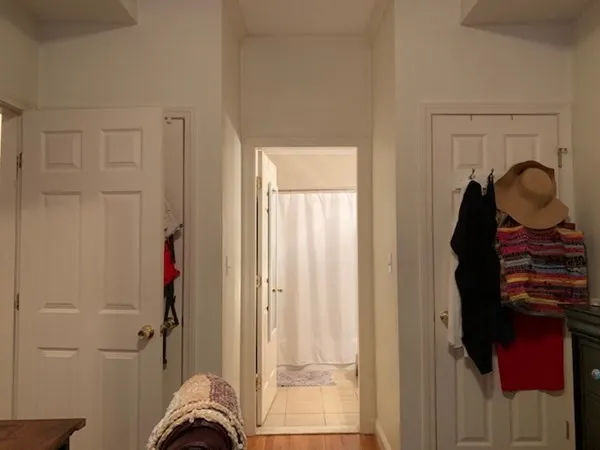 a view of hallway with furniture and a gate