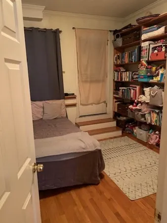 a bedroom with a bed and a book shelf