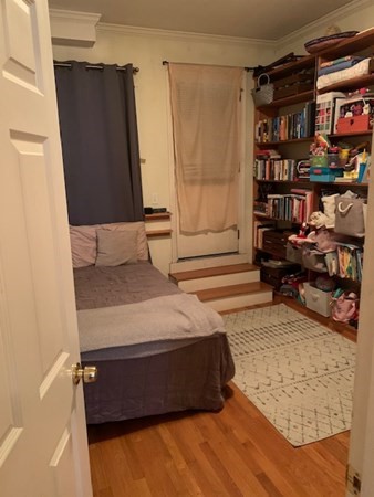 328 Sumner Street, Unit 2 Boston, MA 02128 - Photo 10 of 15 a bedroom with a bed and a book shelf