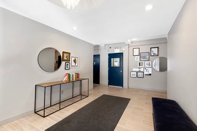 a living room with furniture and a mirror