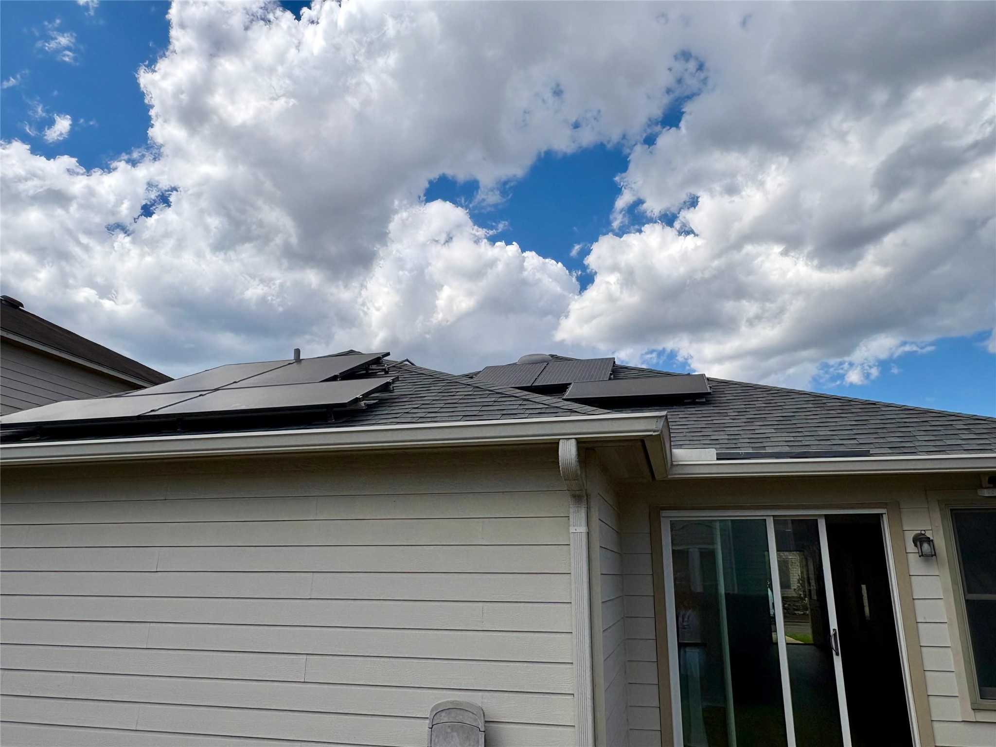 8003 Bannock Lane Austin, TX 78747 - Photo 37 of 40 Exterior view of a shingled roof, gutters, and a downspout