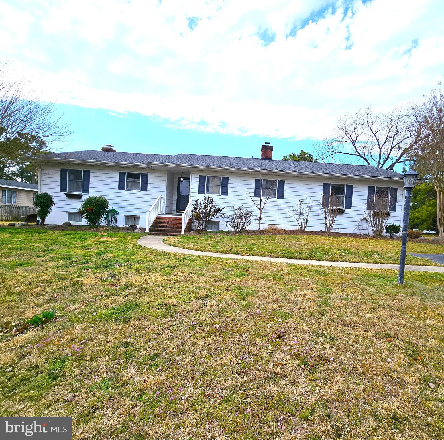 a view of a house with a yard patio and swimming pool