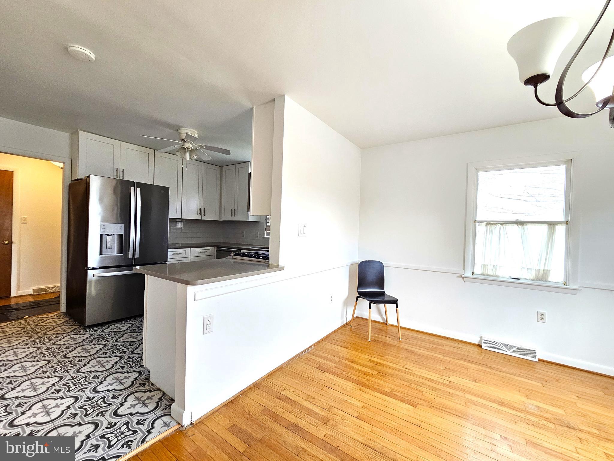 103 Shawnee Circle Cambridge, MD 21613 - Photo 16 of 49 a kitchen with stainless steel appliances kitchen island a refrigerator sink and cabinets