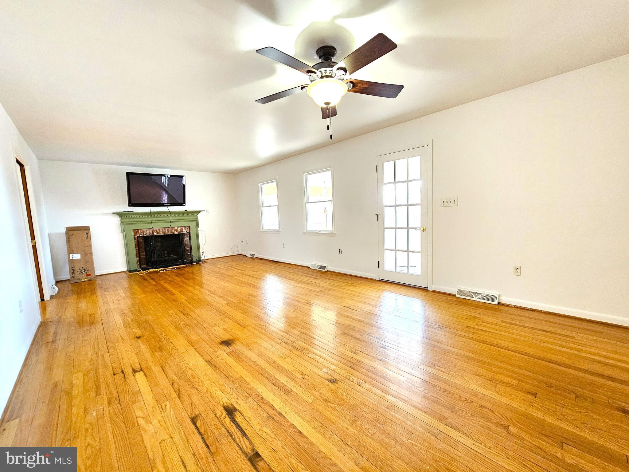 103 Shawnee Circle Cambridge, MD 21613 - Photo 17 of 49 a view of a livingroom with a fireplace a ceiling fan and wooden floor