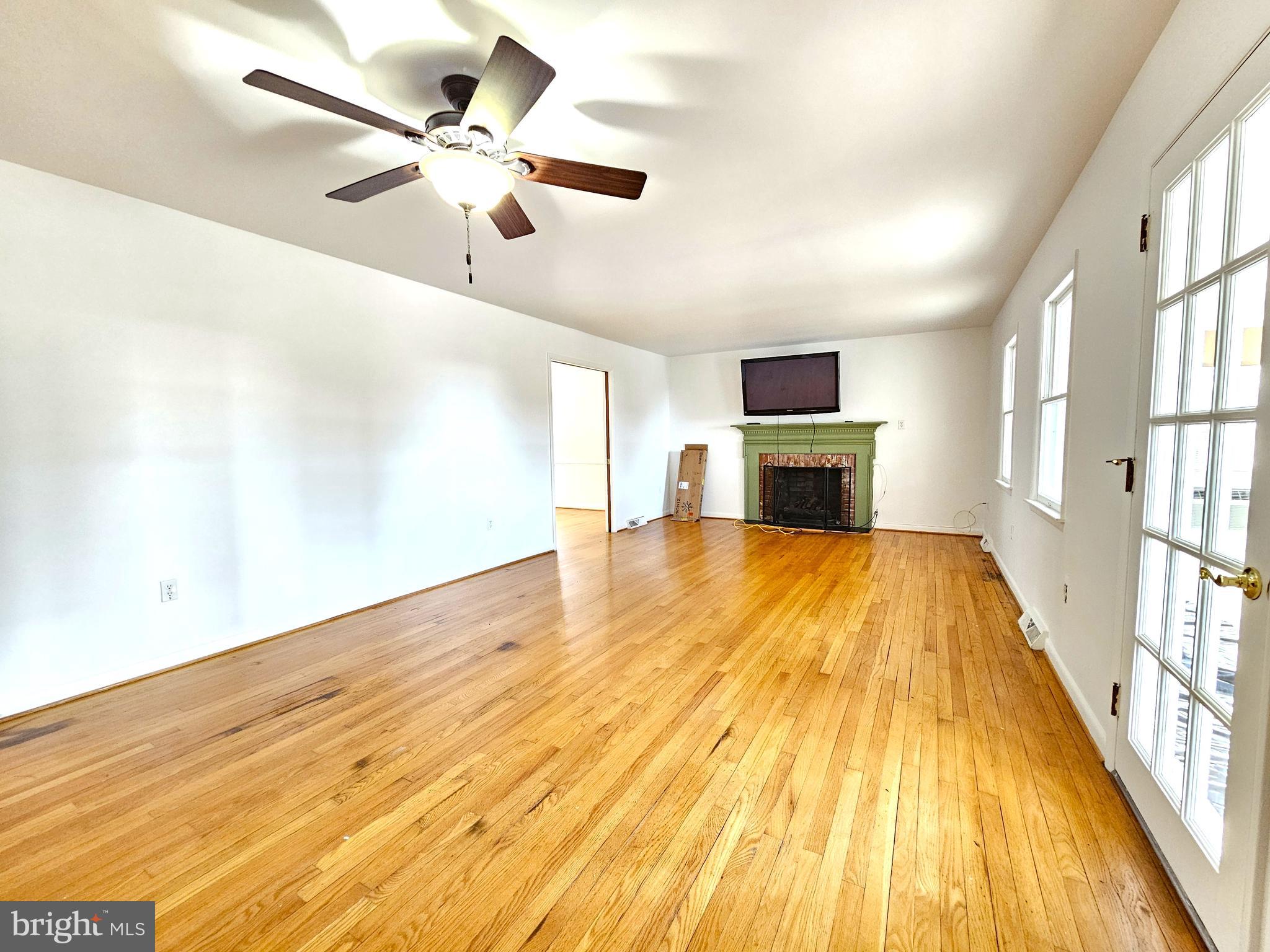 103 Shawnee Circle Cambridge, MD 21613 - Photo 18 of 49 a big room with wooden floor a ceiling fan and windows