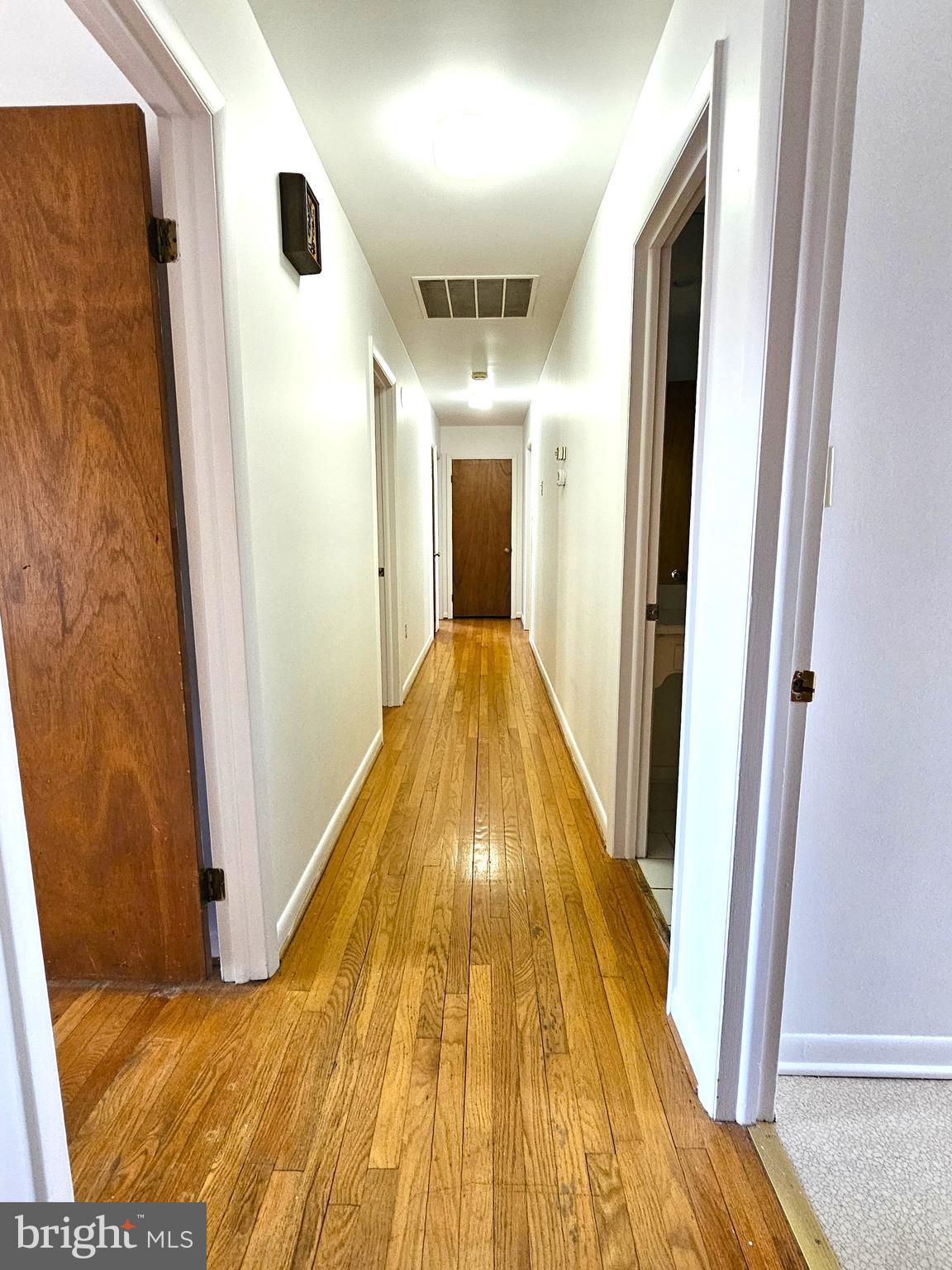 103 Shawnee Circle Cambridge, MD 21613 - Photo 28 of 49 a view of a hallway with wooden floor and cabinet