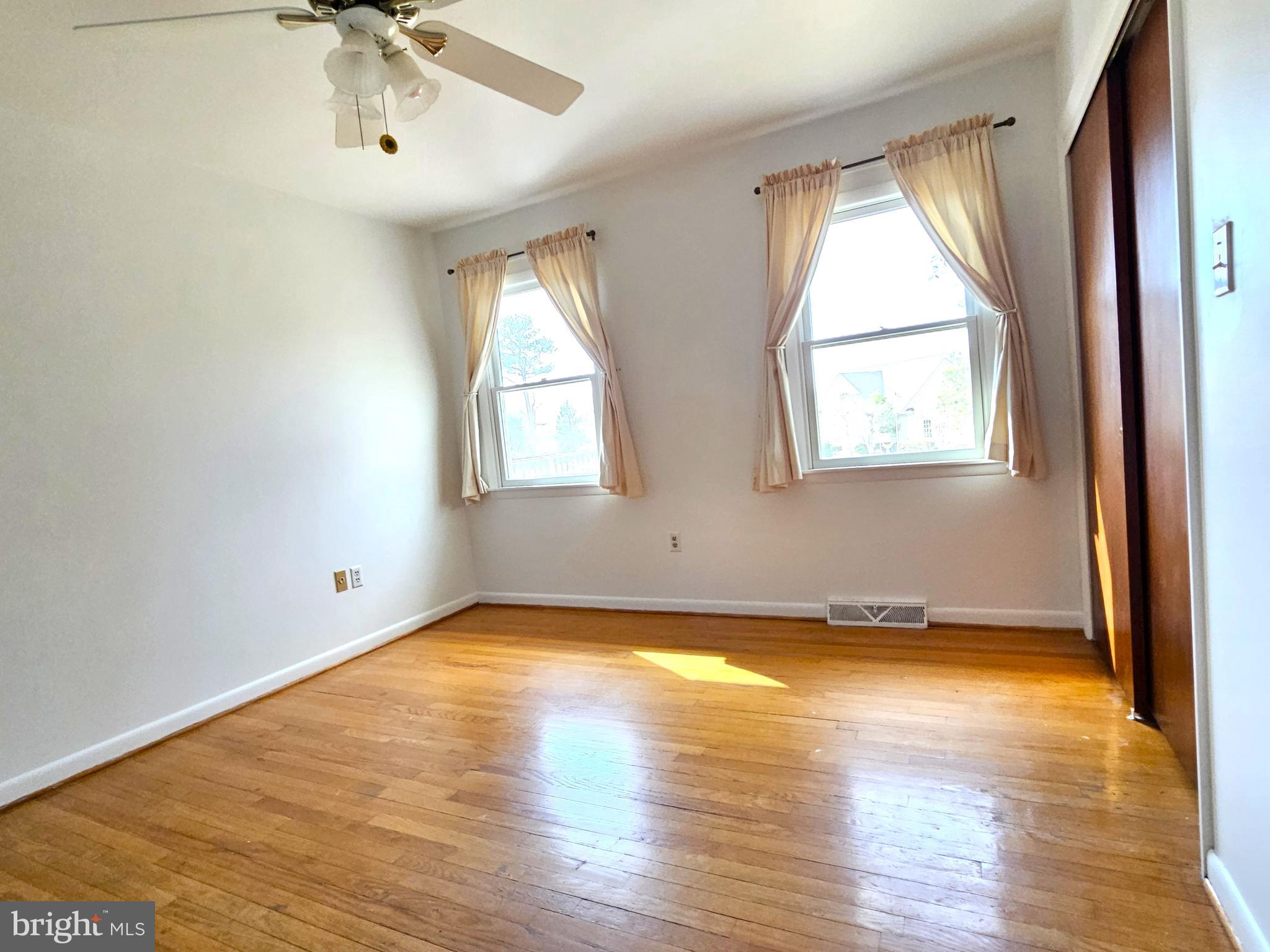103 Shawnee Circle Cambridge, MD 21613 - Photo 33 of 49 a view of an empty room with a window and wooden floor