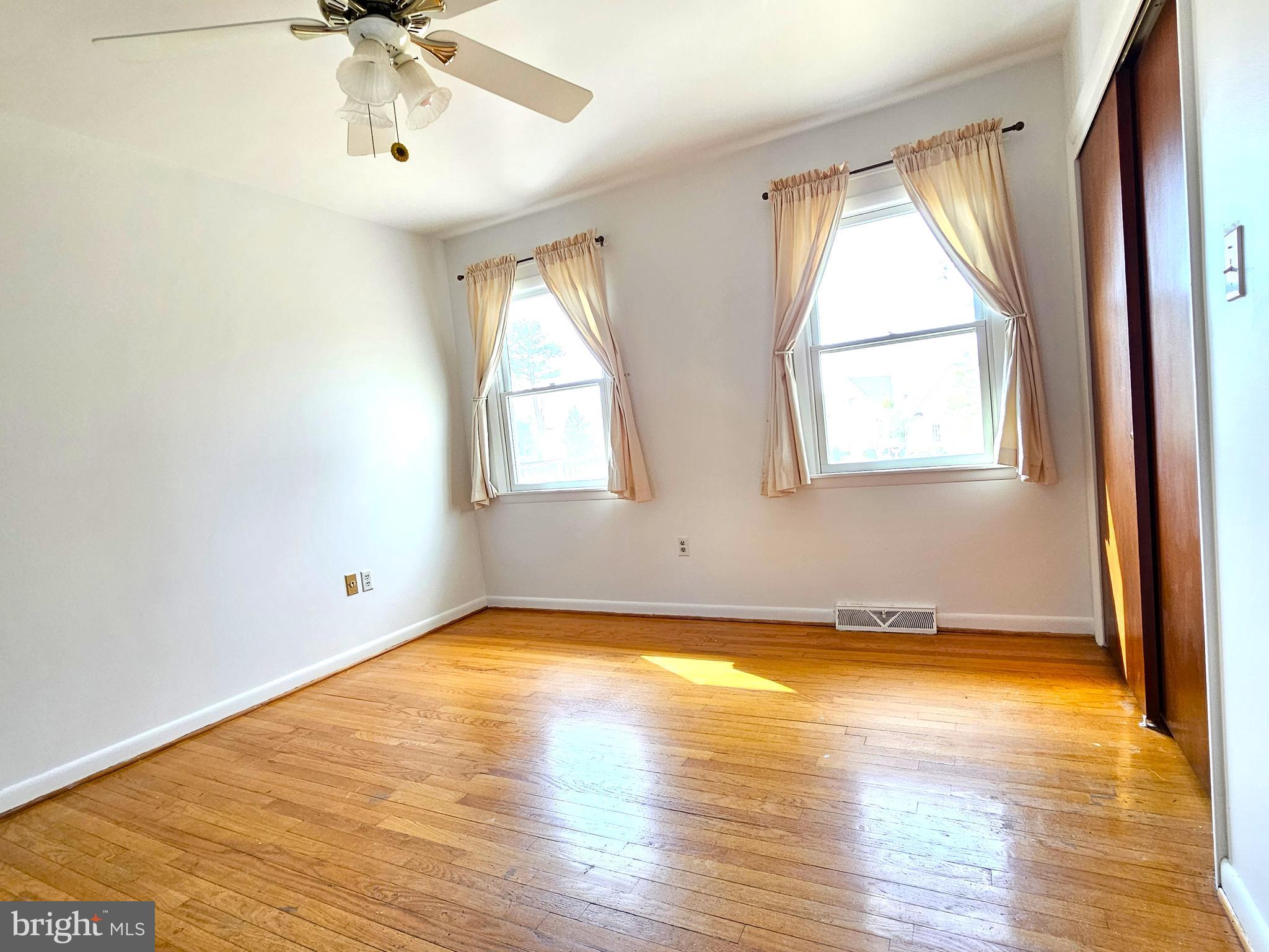 103 Shawnee Circle Cambridge, MD 21613 - Photo 34 of 49 an empty room with wooden floor and windows