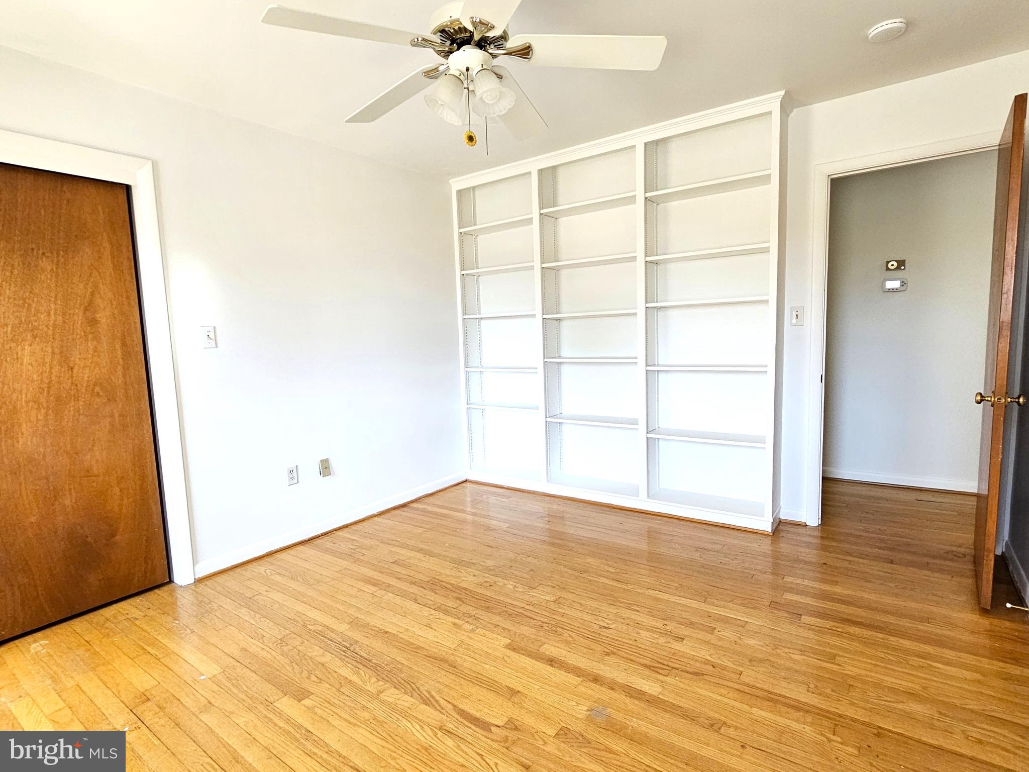 103 Shawnee Circle Cambridge, MD 21613 - Photo 35 of 49 a view of empty room with wooden floor and fan
