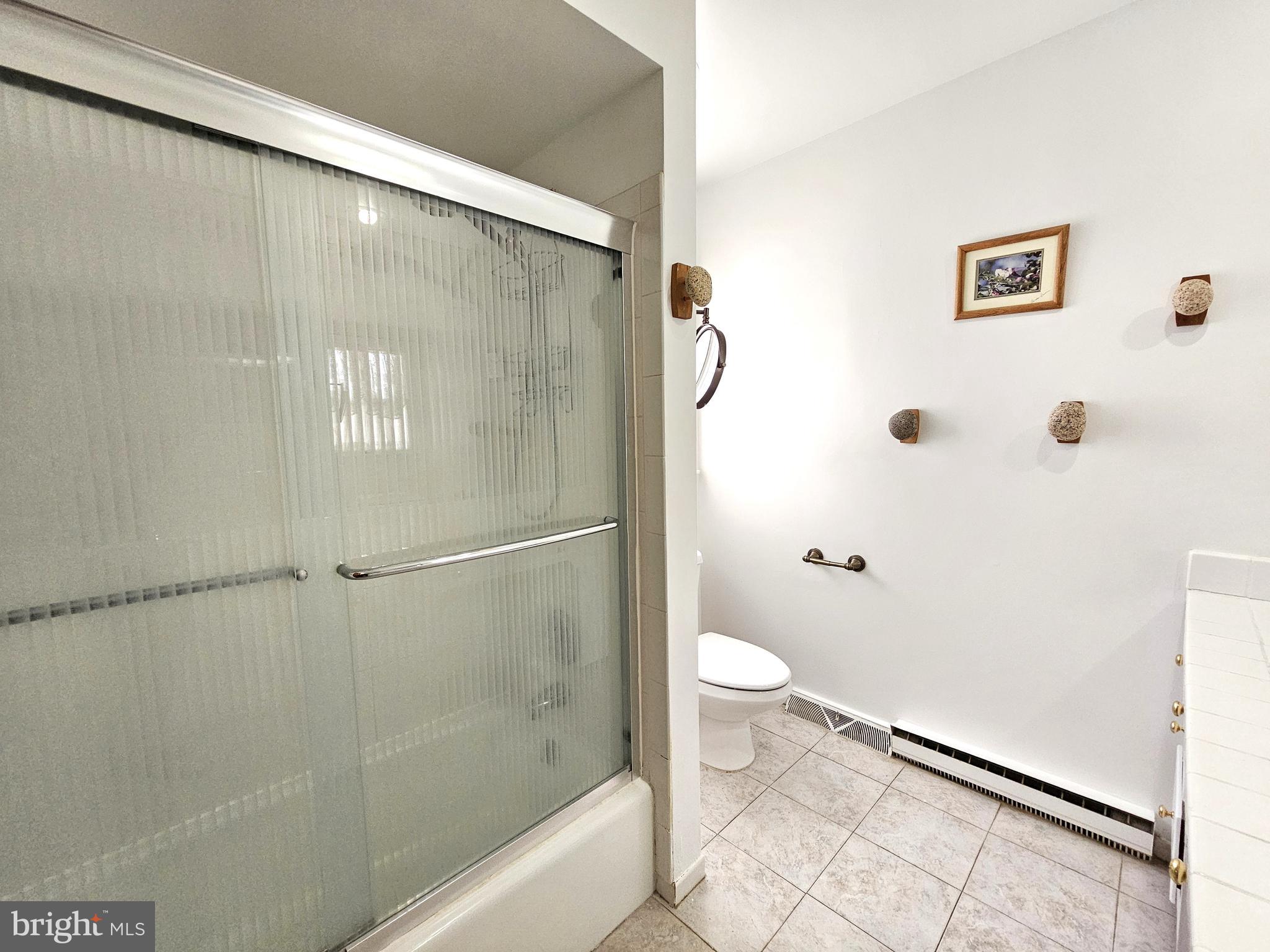 103 Shawnee Circle Cambridge, MD 21613 - Photo 41 of 49 a bathroom with a granite countertop shower and a toilet