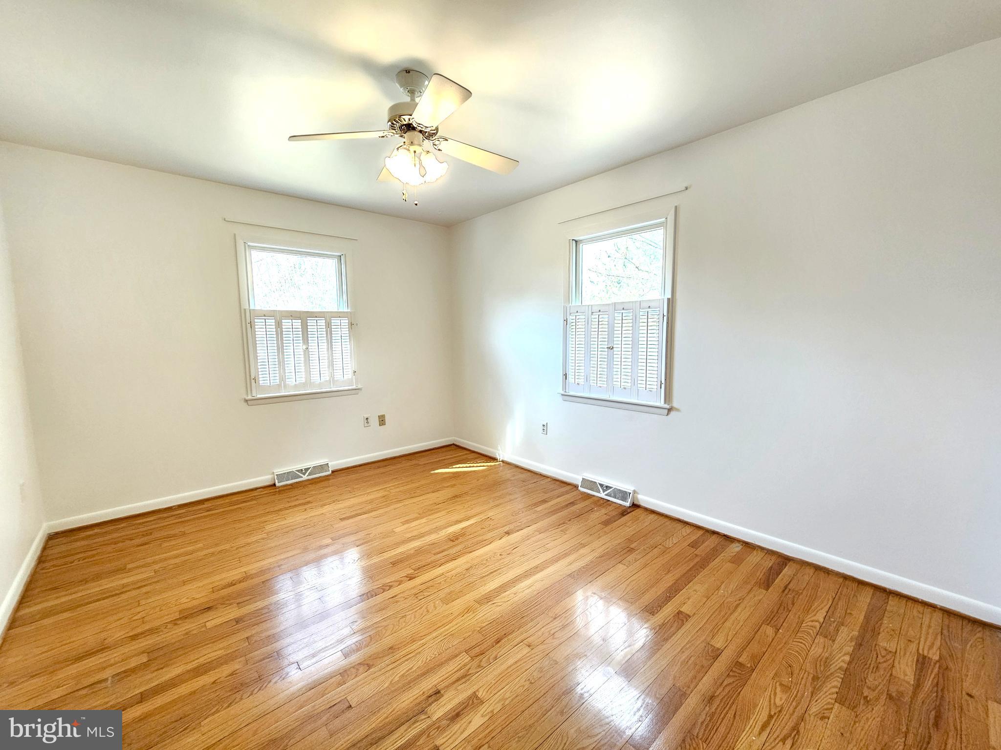 103 Shawnee Circle Cambridge, MD 21613 - Photo 43 of 49 a view of an empty room with wooden floor and a window