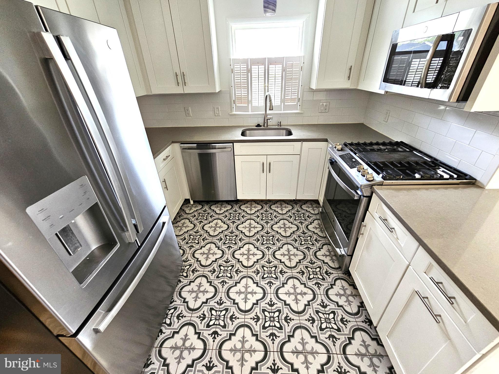 103 Shawnee Circle Cambridge, MD 21613 - Photo 9 of 49 a kitchen with a sink stove and cabinets