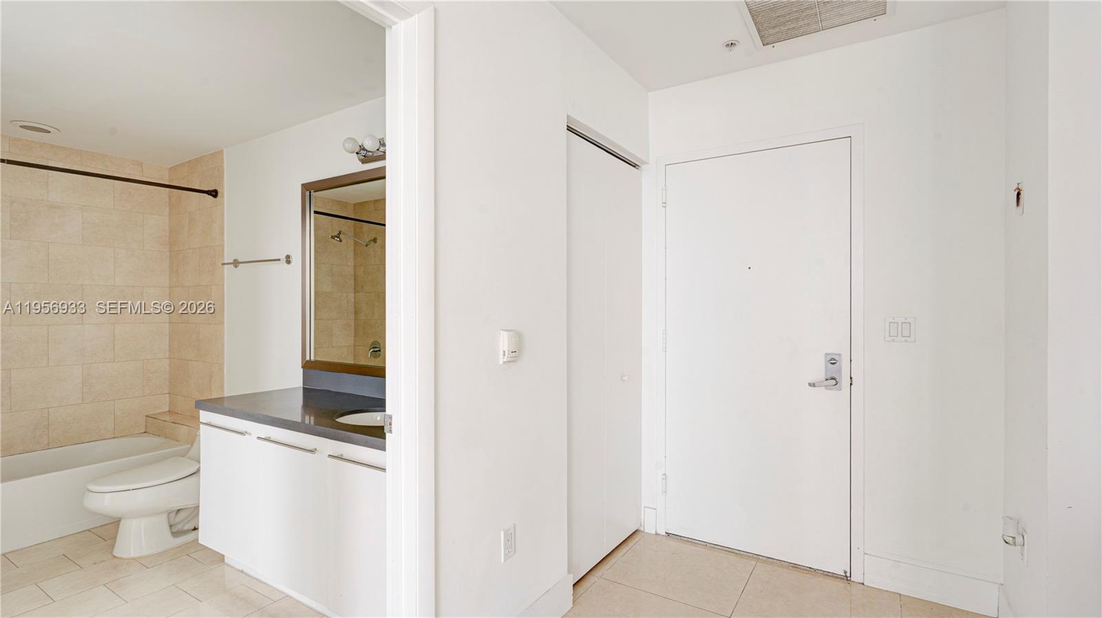 90 Southwest 3rd Street, Unit PH10 Miami, FL 33130 - Photo 20 of 31 a bathroom with a granite countertop sink toilet and shower