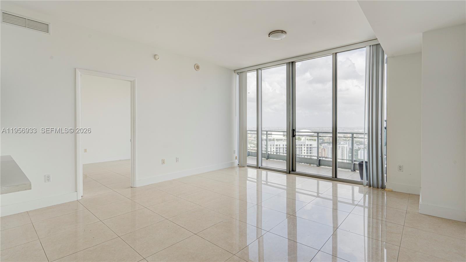 90 Southwest 3rd Street, Unit PH10 Miami, FL 33130 - Photo 2 of 31 a view of an empty room with a window