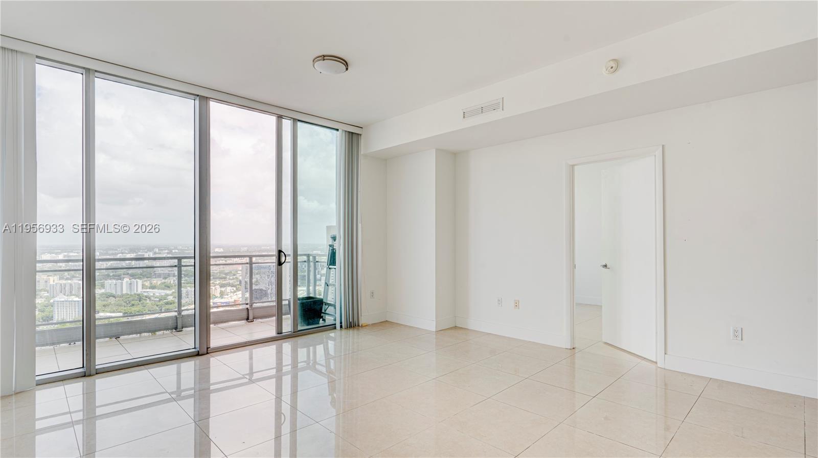 90 Southwest 3rd Street, Unit PH10 Miami, FL 33130 - Photo 7 of 31 a view of an empty room and window