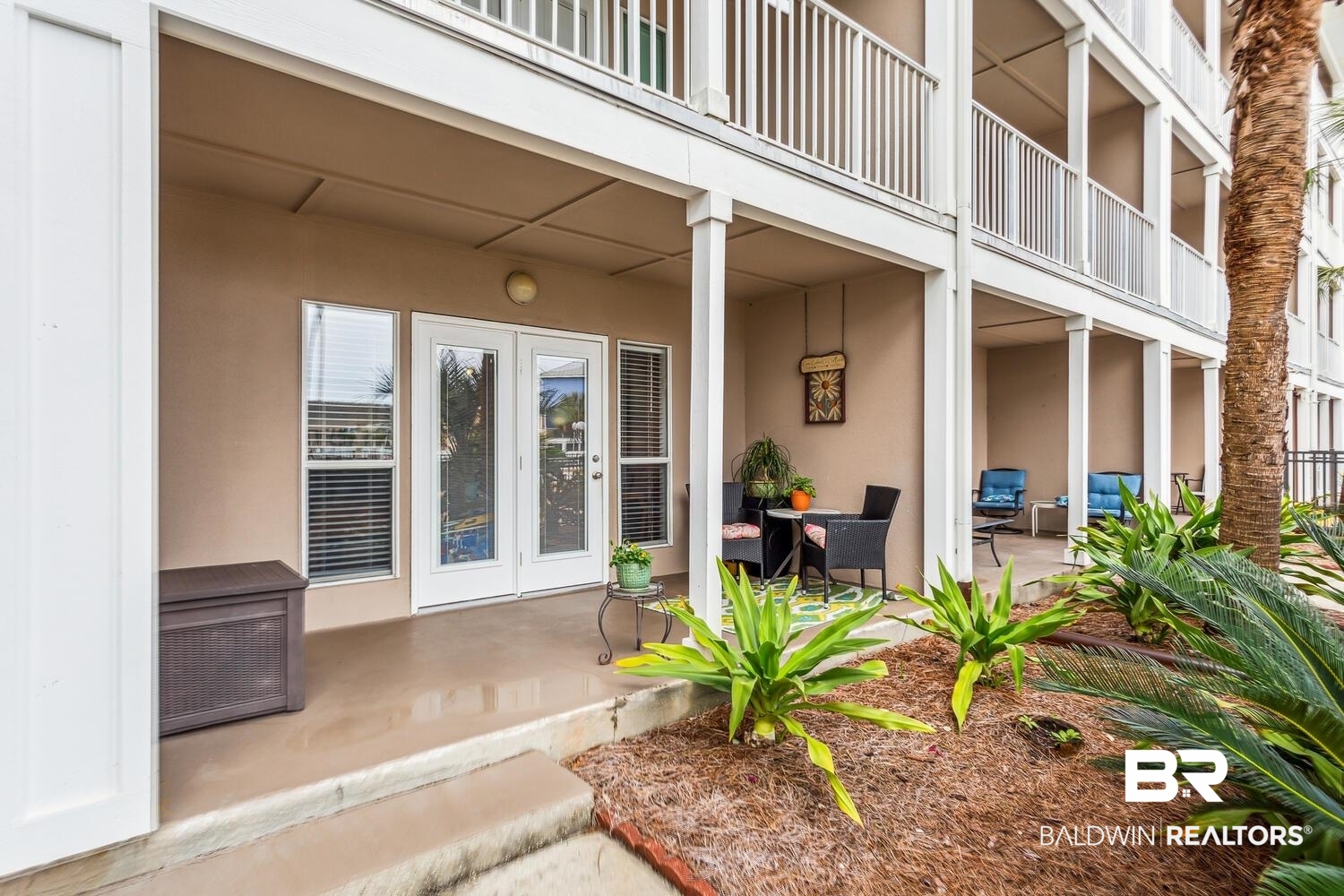 13551 Johnson Beach Road, Unit 112E Pensacola, FL 32507 - Photo 21 of 42 View of exterior entry featuring a patio area