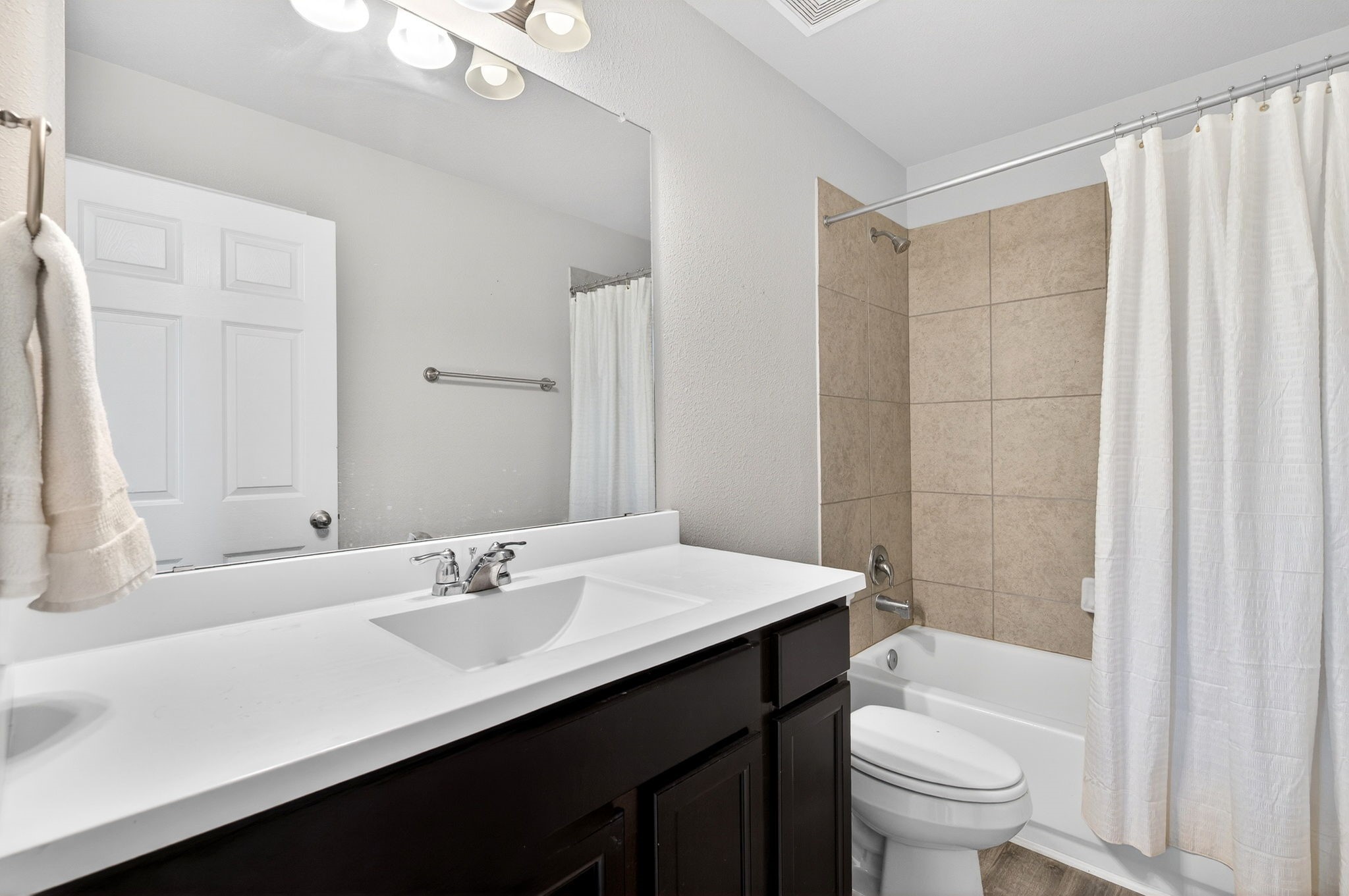 2121 Cedar Way Drive Conroe, TX 77301 - Photo 20 of 27 a bathroom with a sink a toilet a mirror and shower