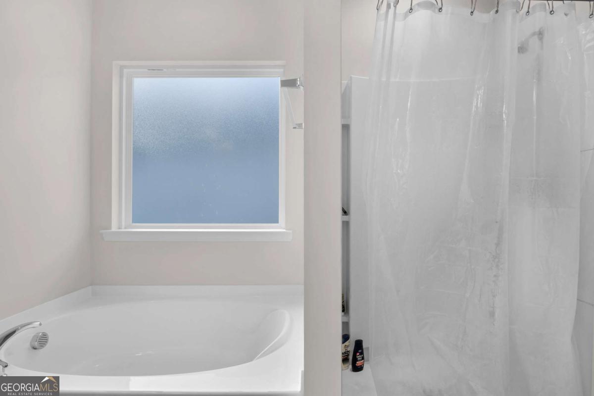 505 Rutledge Drive Hinesville, GA 31313 - Photo 11 of 24 a white bath tub sitting next to a shower