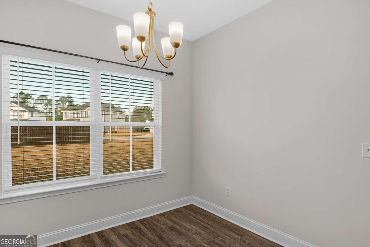 505 Rutledge Drive Hinesville, GA 31313 - Photo 21 of 24 a view of a room with wooden floor and a window