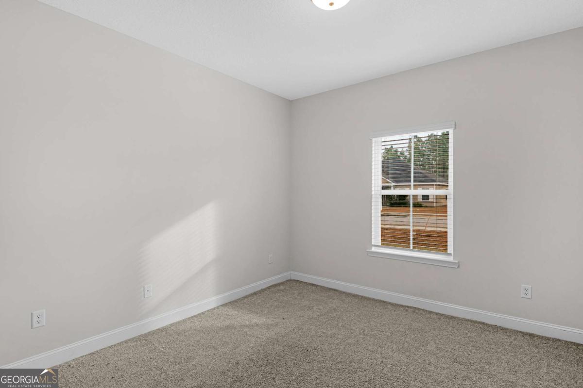 505 Rutledge Drive Hinesville, GA 31313 - Photo 3 of 24 an empty room with a window
