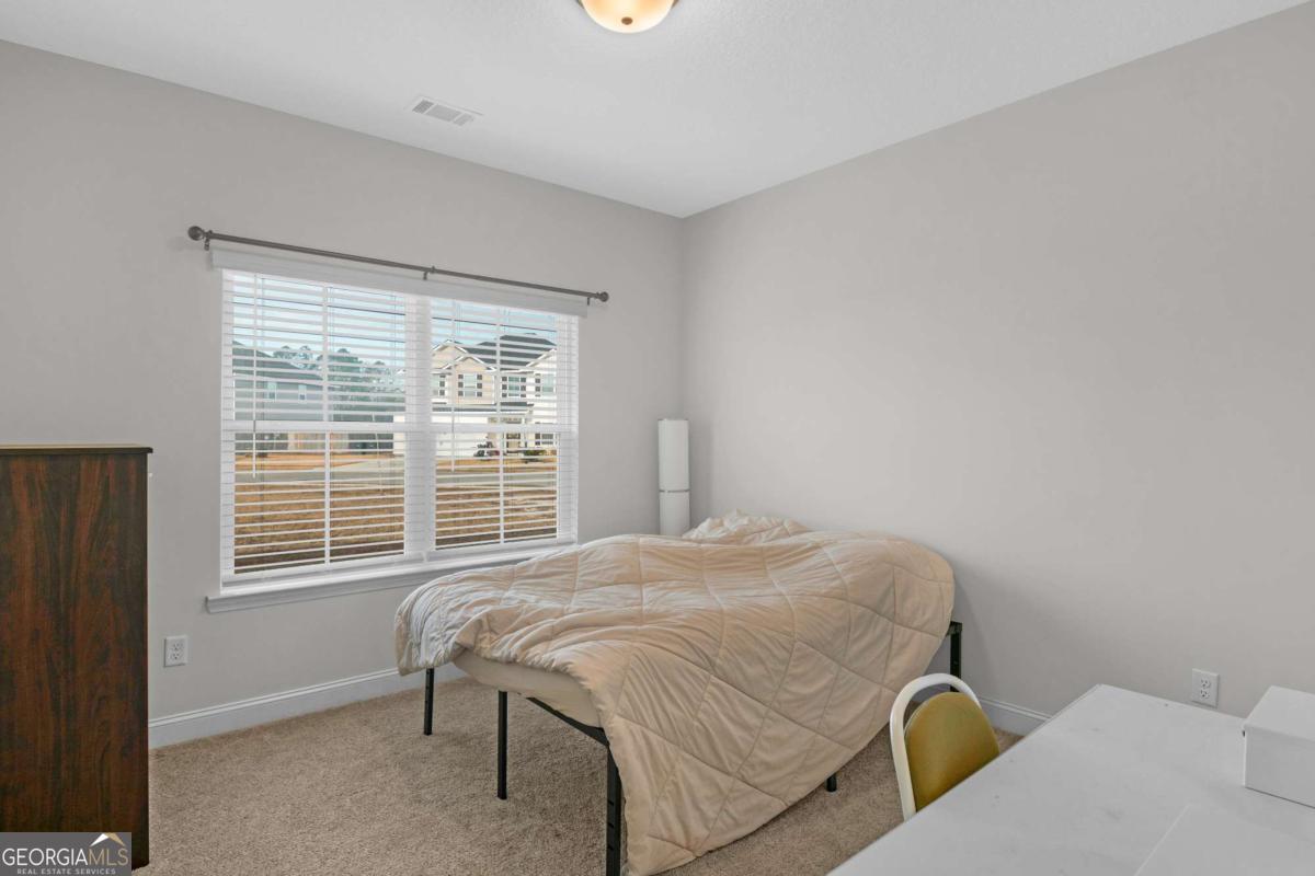 505 Rutledge Drive Hinesville, GA 31313 - Photo 5 of 24 a bedroom with a bed and a window