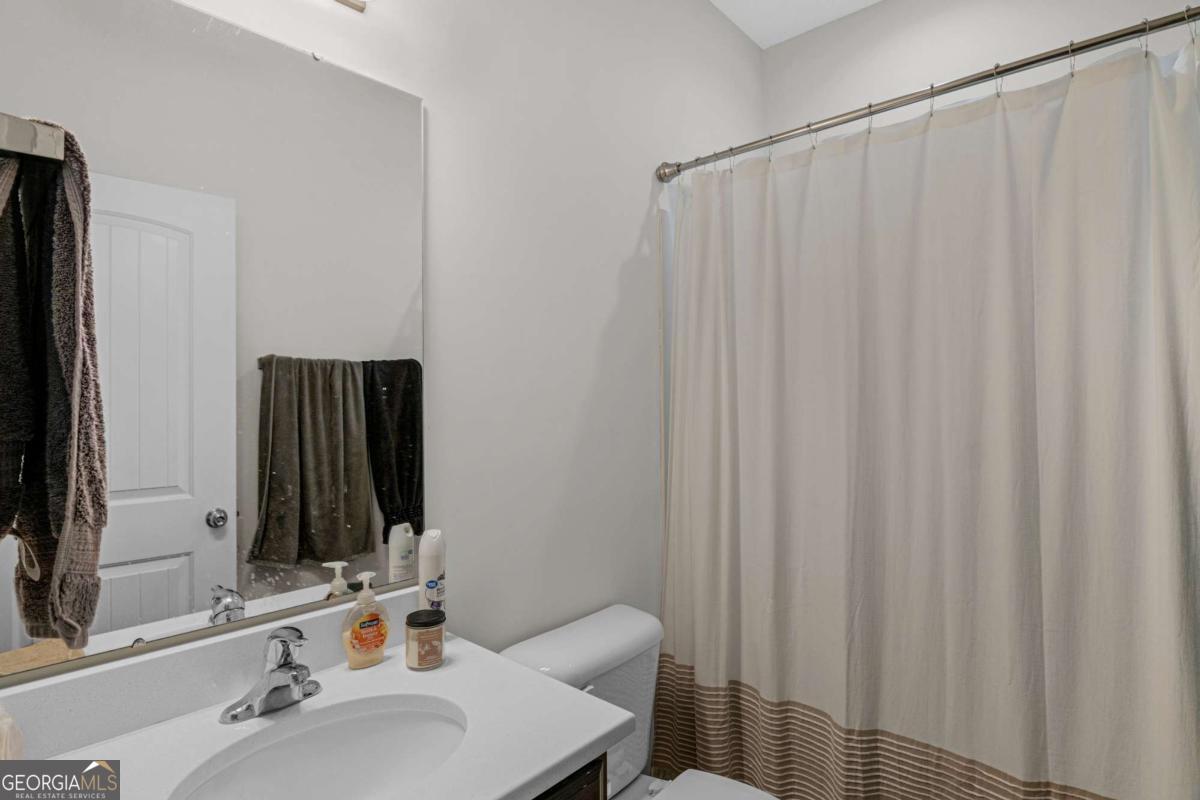 505 Rutledge Drive Hinesville, GA 31313 - Photo 7 of 24 a bathroom with a sink and a mirror