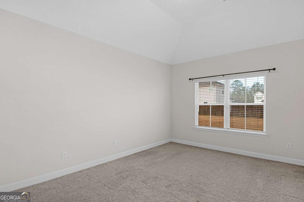 505 Rutledge Drive Hinesville, GA 31313 - Photo 8 of 24 an empty room with a window