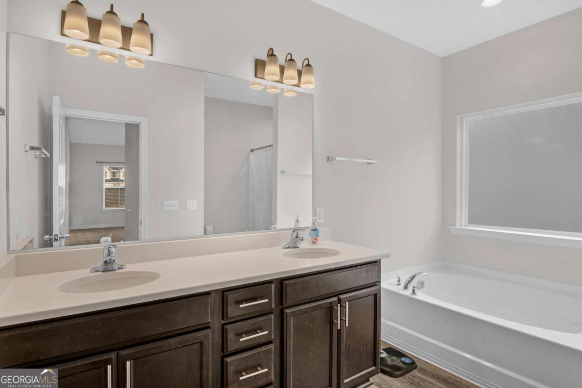 505 Rutledge Drive Hinesville, GA 31313 - Photo 10 of 24 a bathroom with a sink double vanity granite tub and a mirror