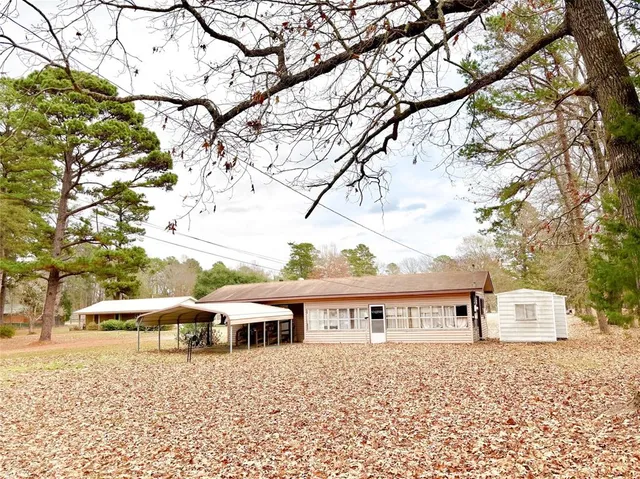 a large house with a tree in front of it