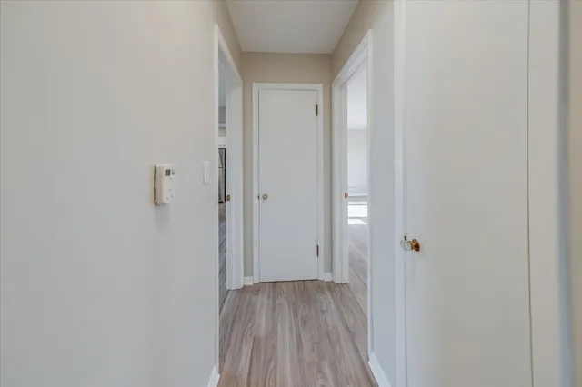 a view of a hallway with wooden floor