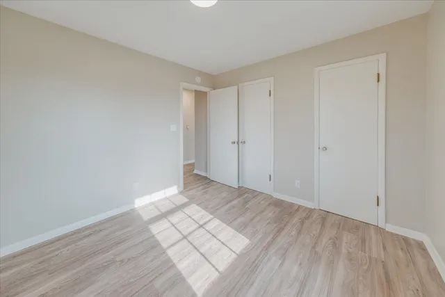 a view of an empty room and wooden floor