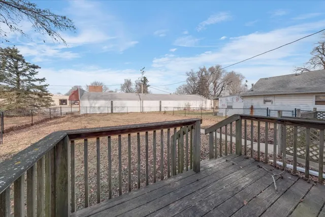 a view of a balcony with wooden fence