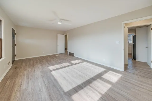 a view of an empty room and wooden floor
