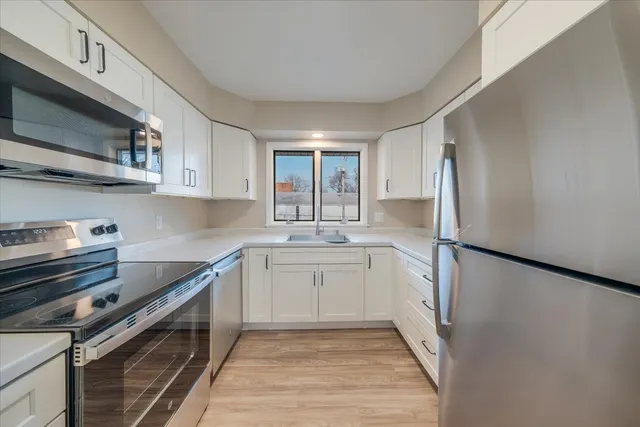 a kitchen with a sink stove and refrigerator