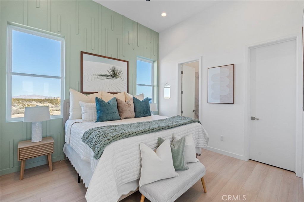 62050 Sonora Road Joshua Tree, CA 92252 - Photo 16 of 40 a spacious bedroom with a bed and a window