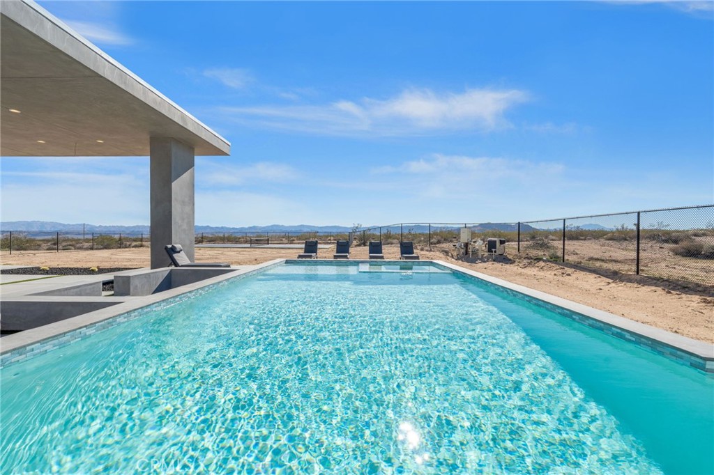 62050 Sonora Road Joshua Tree, CA 92252 - Photo 30 of 40 a view of a backyard with lawn chairs