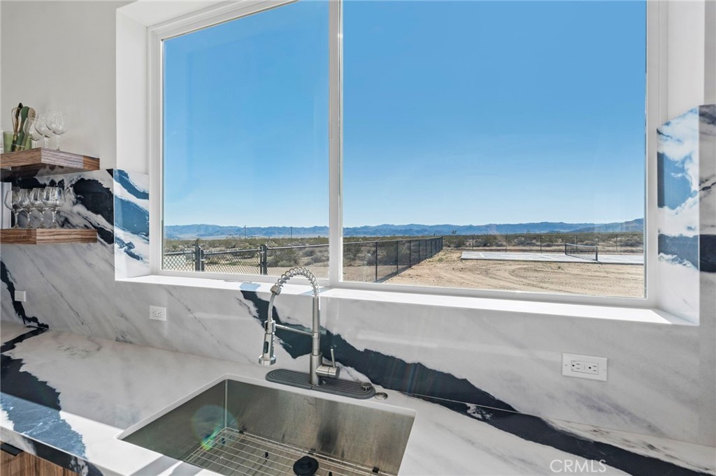 62050 Sonora Road Joshua Tree, CA 92252 - Photo 9 of 40 a view of a kitchen with a sink and living room