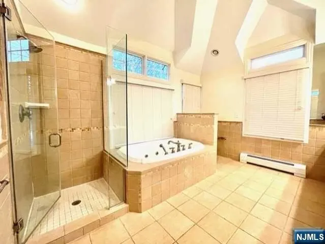 a bathroom with a tub sink and shower