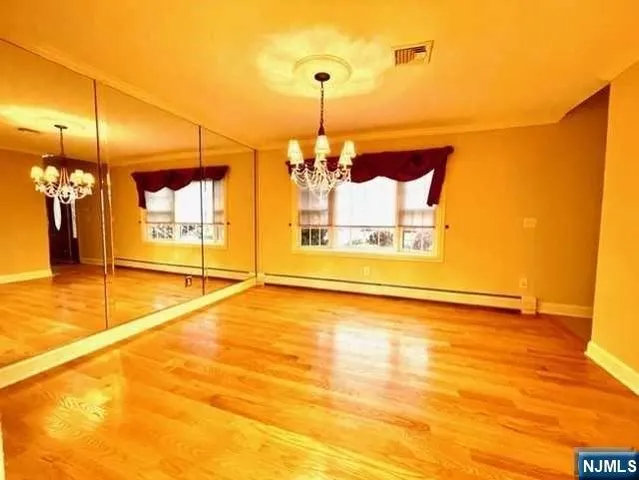 a view of a room with window and a chandelier