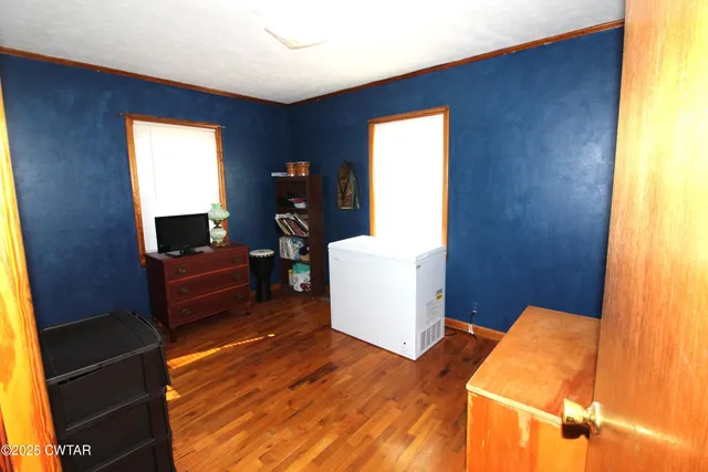 a room with furniture mirror and a wooden floor