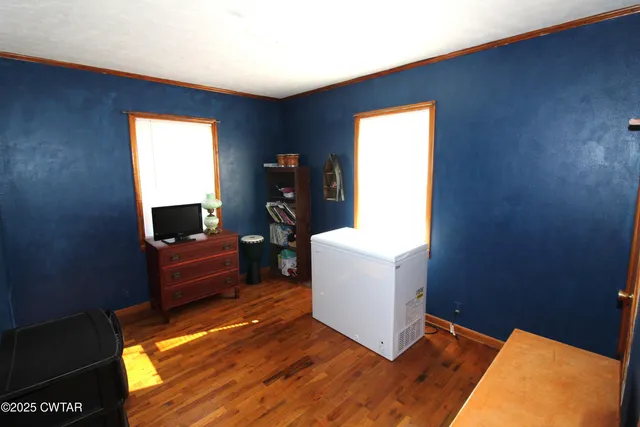 a bedroom with a bed and a dresser in it