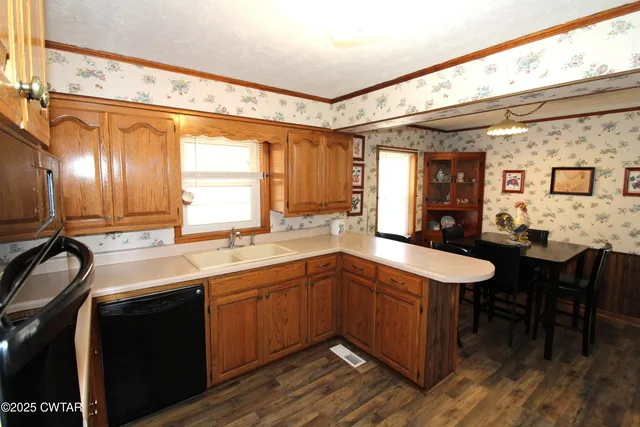 a kitchen with a sink and chairs
