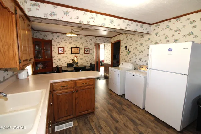 a kitchen with stainless steel appliances a refrigerator and a sink