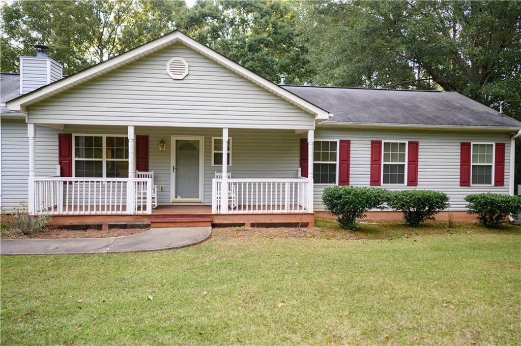1581 Highway 77 Union Point, GA 30669 - Photo 1 of 17 a front view of a house with a yard