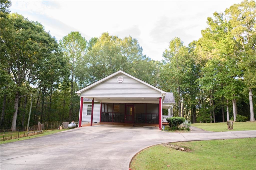 1581 Highway 77 Union Point, GA 30669 - Photo 16 of 17 a front view of a house with a yard and trees