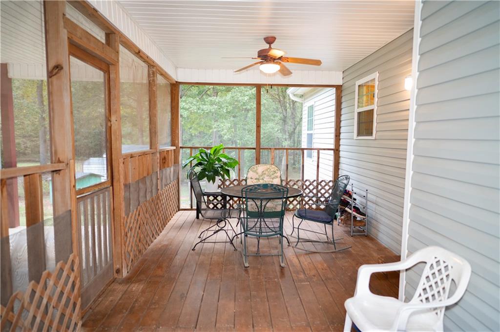 1581 Highway 77 Union Point, GA 30669 - Photo 3 of 17 a dining room with furniture wooden floor and a rug