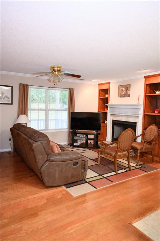 1581 Highway 77 Union Point, GA 30669 - Photo 4 of 17 a living room with furniture a fireplace and a flat screen tv